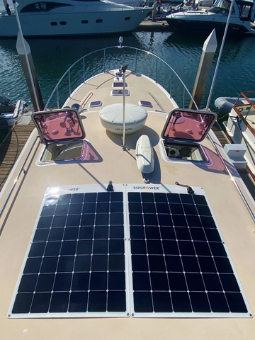 Solar panel on a boat deck with yachts in the background